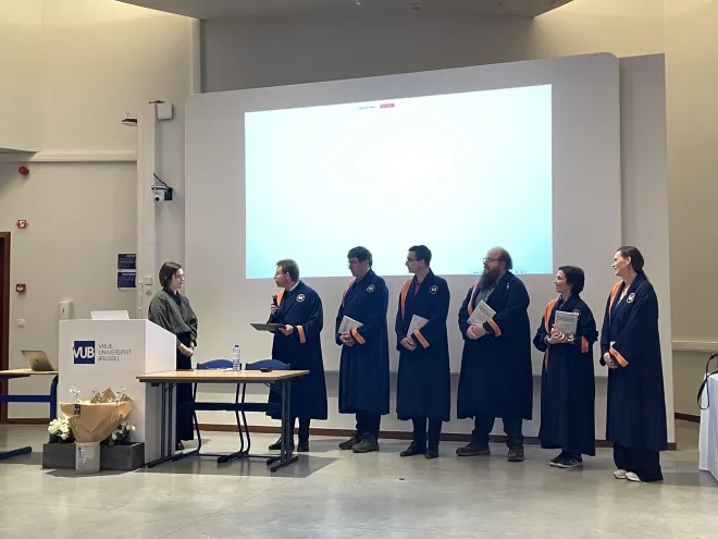 Wim, the chair, presents the PhD certificate